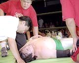 Misawa after being choked out by Akiyama's front neck lock from Nikkan Sports